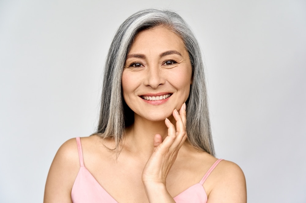 Woman smiling with clear skin after VeinGogh System treatment for facial veins in Tampa